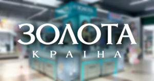 Logo banner reading 'ЗОЛОТА КРАЇНА' with a blurred shopping mall kiosk background.